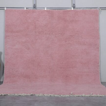 Authentic handmade Moroccan millennial pink rug, crafted from 100% natural wool using traditional Beni Ourain weaving. This soft and elegant solid pink area rug is perfect for modern interiors, bedrooms, or boho living rooms.