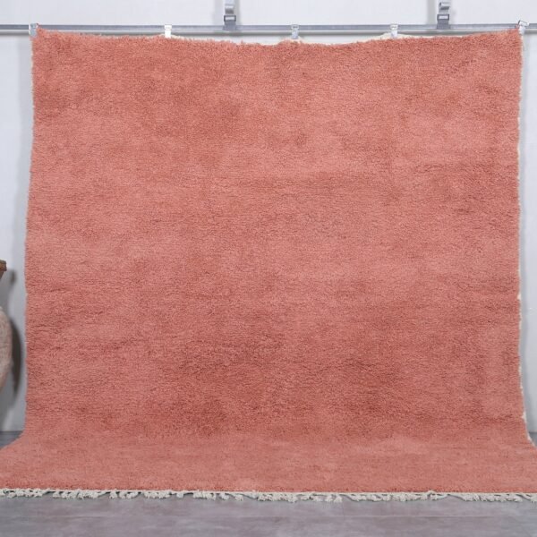 Handmade Moroccan blush pink wool rug with soft Beni Ourain texture.