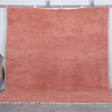 Handmade Moroccan blush pink wool rug with soft Beni Ourain texture.