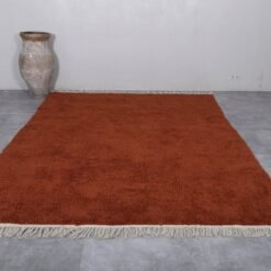custom warm terracotta Moroccan rug showcasing its thick plush wool texture and traditional Berber handwoven craftsmanship, ideal for living rooms and bedrooms.