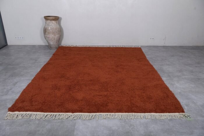 custom warm terracotta Moroccan rug showcasing its thick plush wool texture and traditional Berber handwoven craftsmanship, ideal for living rooms and bedrooms.