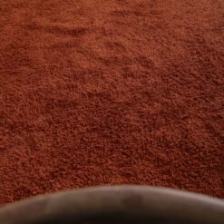 solid warm terracotta Moroccan wool rug, highlighting its dense pile and minimalist design, handmade with natural lamb wool for lasting durability.
