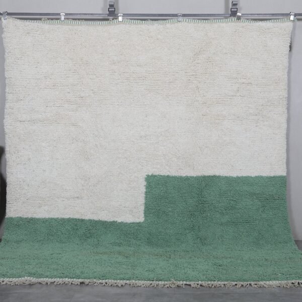 Handmade ivory and green Moroccan wool rug crafted by Berber artisans using 100% natural lamb wool, featuring traditional Beni Ourain design for a timeless, earthy aesthetic.