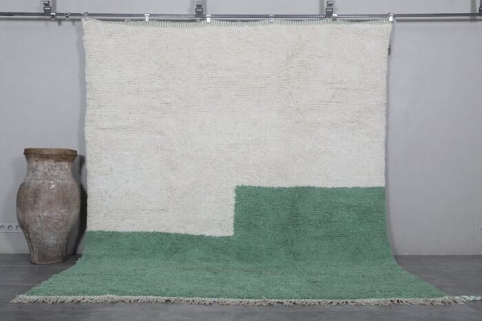Handmade ivory and green Moroccan wool rug crafted by Berber artisans using 100% natural lamb wool, featuring traditional Beni Ourain design for a timeless, earthy aesthetic.