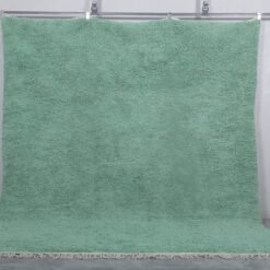 handmade mint green Moroccan rug, showing the fine wool texture and subtle color. Handwoven by Berber women, this rug adds calm and character to modern, minimalist, or Scandinavian-style rooms.