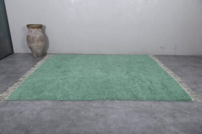 Moroccan Berber rug, displaying its solid color, symmetrical shape, and authentic fringe edges. A perfect handmade centerpiece for peaceful, bright home decor.