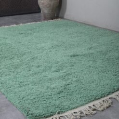 mint green Moroccan rug, showing the thick wool fibers and precise hand-knotting. A perfect example of traditional Berber artistry blended with soft pastel elegance.