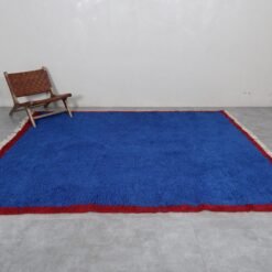 Moroccan Blue Beni Ourain rug illustrating its authentic Berber design and vibrant blue coloration. Hand-knotted with natural sheep wool by Moroccan women artisans, this perspective highlights the rug’s thickness, texture, and cultural significance, making it a perfect centerpiece for large rooms or statement décor.