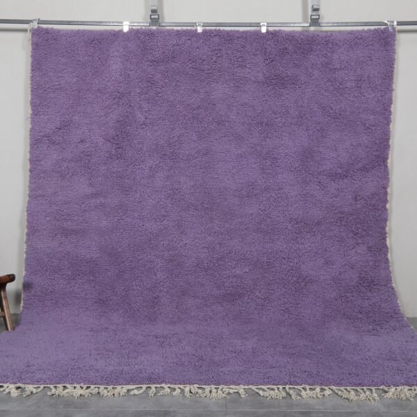 Handmade Moroccan Berber rug in rich iris purple color, crafted with 100% natural wool by Atlas Mountain artisans. This elegant Beni Ourain rug adds depth, warmth, and artistic flair to modern interiors. Ideal for stylish living rooms, bedrooms, or statement entryways.