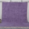 Handmade Moroccan Berber rug in rich iris purple color, crafted with 100% natural wool by Atlas Mountain artisans. This elegant Beni Ourain rug adds depth, warmth, and artistic flair to modern interiors. Ideal for stylish living rooms, bedrooms, or statement entryways.