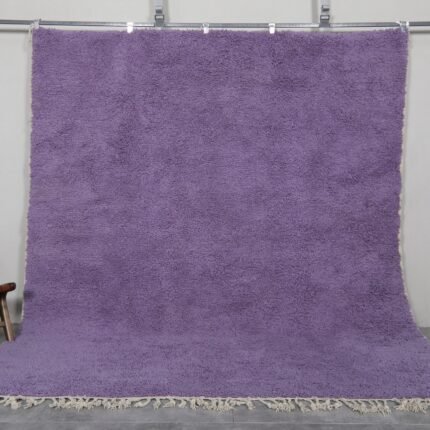 Handmade Moroccan Berber rug in rich iris purple color, crafted with 100% natural wool by Atlas Mountain artisans. This elegant Beni Ourain rug adds depth, warmth, and artistic flair to modern interiors. Ideal for stylish living rooms, bedrooms, or statement entryways.