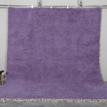 Handmade Moroccan Berber rug in rich iris purple color, crafted with 100% natural wool by Atlas Mountain artisans. This elegant Beni Ourain rug adds depth, warmth, and artistic flair to modern interiors. Ideal for stylish living rooms, bedrooms, or statement entryways.