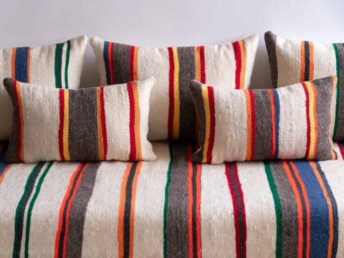 Unstuffed Moroccan floor cushions with zippered covers laid flat for filling