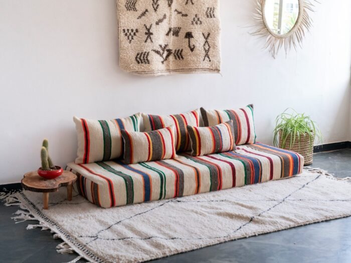 Boho living room with ivory lamb wool Moroccan floor sofa set featuring multicolor stripes