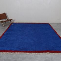 Moroccan Blue Beni Ourain rug, highlighting the intricate handwoven texture and rich blue hues. Crafted from soft, natural sheep wool by expert Moroccan artisans, this detailed shot showcases the high-quality fibers and artisan craftsmanship that give the rug its durable yet plush feel.