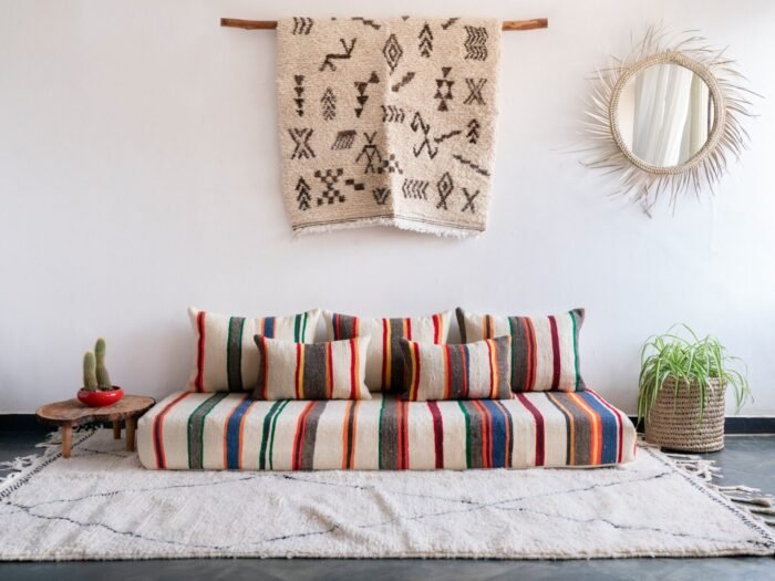 Handmade Moroccan wool floor sofa set with ivory lamb wool base and vibrant multicolor striped embroidery, unstuffed cushion covers with hidden zippers