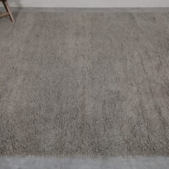 Top-down view of taupe Moroccan Beni Ourain rug with solid wool surface.