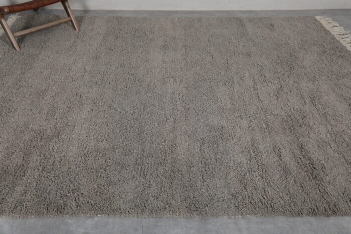 Top-down view of taupe Moroccan Beni Ourain rug with solid wool surface.