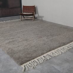 Fringe detail of handmade taupe Moroccan rug crafted by Berber artisans.