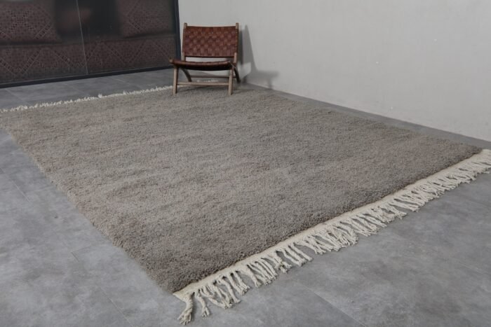 Fringe detail of handmade taupe Moroccan rug crafted by Berber artisans.