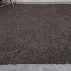 Moroccan dark gray wool rug, hand-knotted with care by skilled Berber women, customizable and timeless.