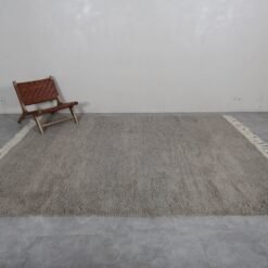 Right side of Moroccan taupe wool rug, showcasing plush texture and minimalist style.