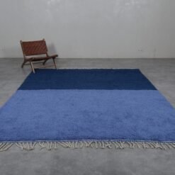 Moroccan rug in cobalt and light blue tones, showing the wool texture and traditional Berber handweaving.