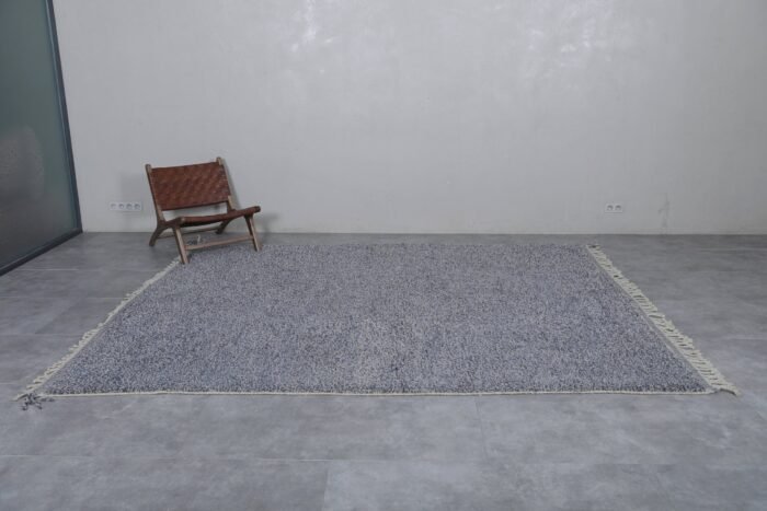 Moroccan charcoal gray wool rug showcasing its solid tone and soft, handwoven texture by Berber artisans
