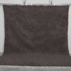 solid dark gray Moroccan area rug, highlighting its elegant, minimalist design and rich texture, made with authentic natural lamb wool.