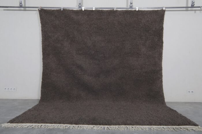 solid dark gray Moroccan area rug, highlighting its elegant, minimalist design and rich texture, made with authentic natural lamb wool.