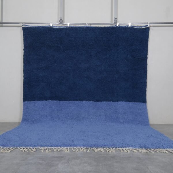 Handmade Moroccan Beni Ourain rug in a light and cobalt blue blend, crafted from 100% natural lamb wool by Berber artisans in the Atlas Mountains.