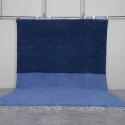 Handmade Moroccan Beni Ourain rug in a light and cobalt blue blend, crafted from 100% natural lamb wool by Berber artisans in the Atlas Mountains.