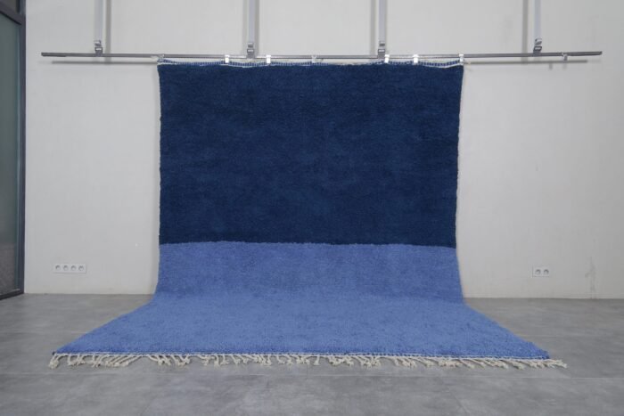 Handmade Moroccan Beni Ourain rug in a light and cobalt blue blend, crafted from 100% natural lamb wool by Berber artisans in the Atlas Mountains.