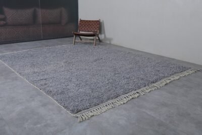 the fringe and border on a handmade charcoal gray Moroccan rug, emphasizing detail and texture.