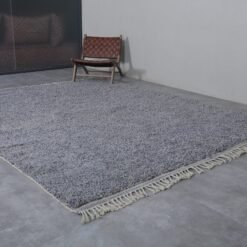 the fringe and border on a handmade charcoal gray Moroccan rug, emphasizing detail and texture.