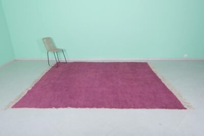 Top-down view of Moroccan plum rug showing solid wool surface and texture.