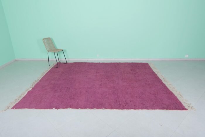 Top-down view of Moroccan plum rug showing solid wool surface and texture.