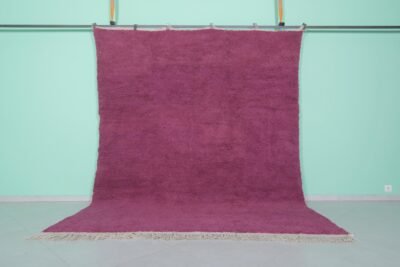 Handmade Moroccan plum wool rug with soft texture and solid Beni Ourain design.