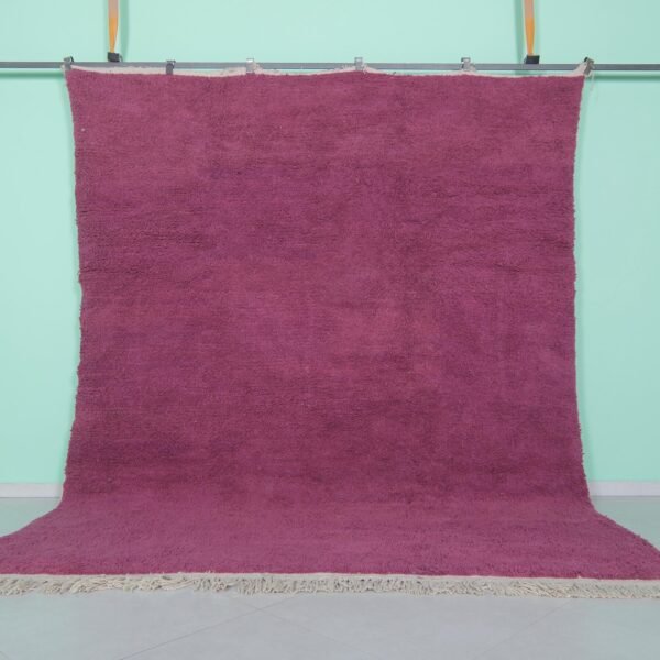 Handmade Moroccan plum wool rug with soft texture and solid Beni Ourain design.