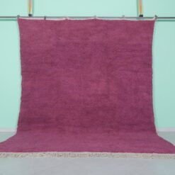 Handmade Moroccan plum wool rug with soft texture and solid Beni Ourain design.
