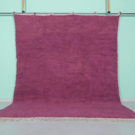 Handmade Moroccan plum wool rug with soft texture and solid Beni Ourain design.