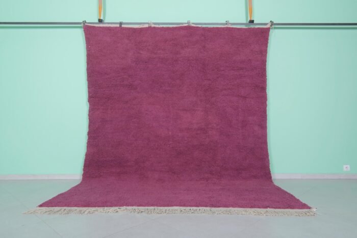 Handmade Moroccan plum wool rug with soft texture and solid Beni Ourain design.