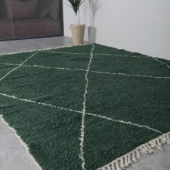 custom Moroccan rug in dark green, emphasizing the rug's plush wool surface and deep, calming color tones.