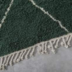 Fringe detail of green wool Moroccan rug with hand-tied ends, showcasing authentic Berber finishing techniques in lamb wool.