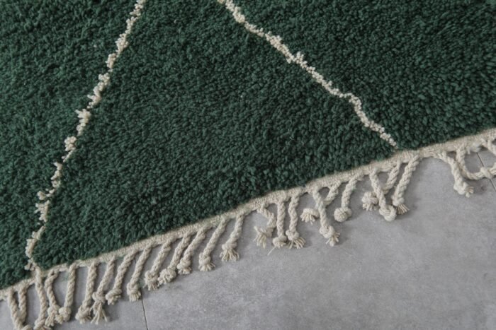 Fringe detail of green wool Moroccan rug with hand-tied ends, showcasing authentic Berber finishing techniques in lamb wool.
