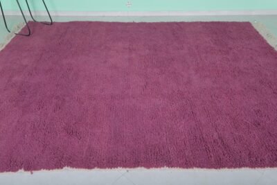 Top-down view of Moroccan plum rug showing solid wool surface and texture.
