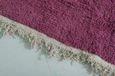 Fringe detail of handmade Moroccan plum Beni Ourain rug in deep purple wool.