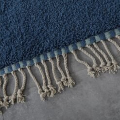 fringe and weave on blue and pistachio Moroccan wool rug, highlighting artisanal craftsmanship and natural wool.