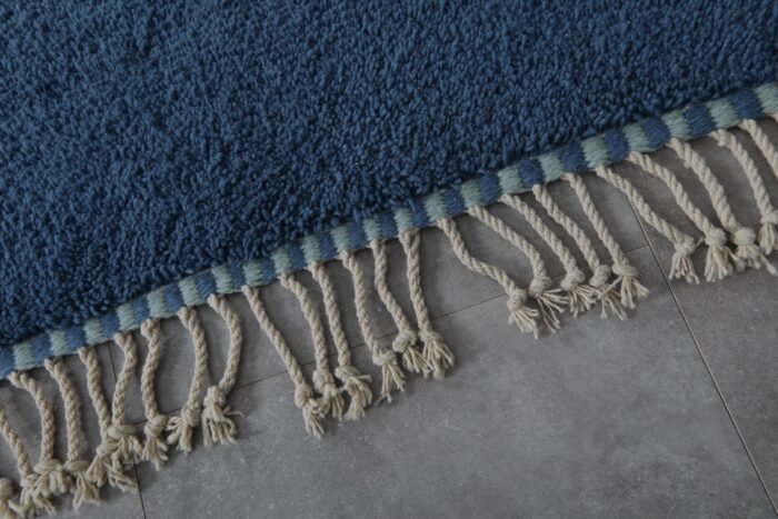 fringe and weave on blue and pistachio Moroccan wool rug, highlighting artisanal craftsmanship and natural wool.