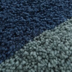 Zoomed-in view of dense lamb wool texture in Moroccan Beni Ourain rug with blue and pistachio hues, emphasizing softness and durability.